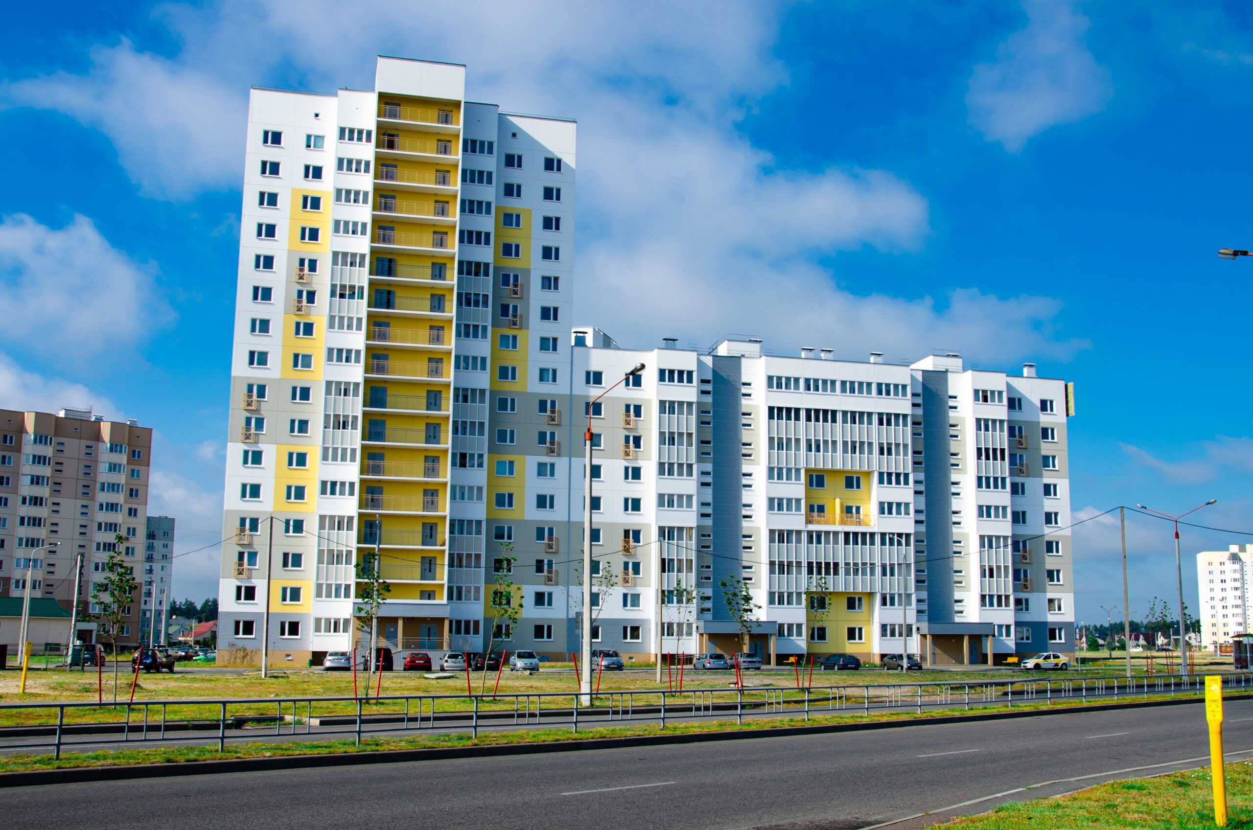 New block of modern apartments with balconies and blue sky in the