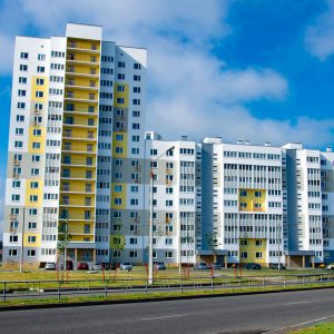 New block of modern apartments with balconies and blue sky in the